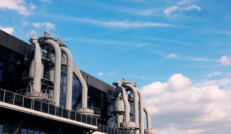 A large industrial building with pipes and windows